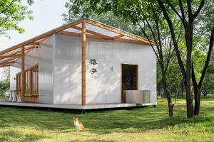A minimalist residential building constructed with metal and glass materials.