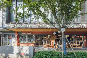 A modern commercial interior with greenery, large glass windows, and a Soofoo logo.