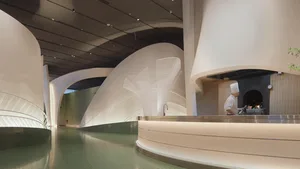 Modern restaurant interior with minimalist design and ceramic tile flooring.