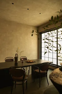 Modern dining room featuring minimalist decor and wooden furniture.