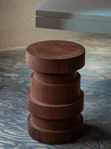 A modern, stacked wood cylinder stool with a round top and three cylindrical sections.