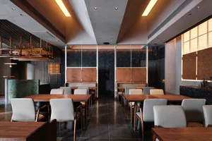 Modern industrial restaurant interior with marble accents and metallic finishes.