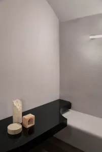 A sleek, modern minimalist corner with concrete materials and simple geometric shapes.