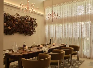 A modern dining room with decorative lighting and elegant furniture.