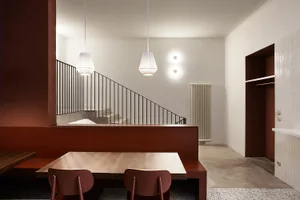 Modern interior design featuring wooden furniture and stairs.