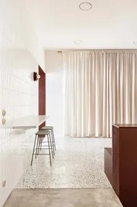 Modern interior space featuring terrazzo flooring and minimalist design elements.