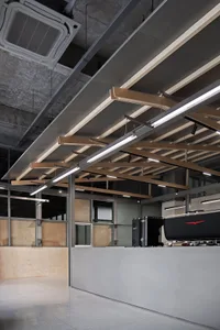 Industrial-style coffee shop counter featuring metal and wood components.
