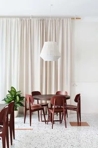 Modern dining room featuring wooden furniture and a round table.