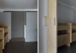 Minimalist interior with wooden cabinets and gray flooring.