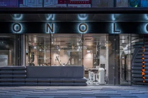 Modern commercial storefront with glass walls showcasing an industrial space.