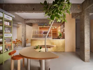 A modern coffee shop interior with wooden furniture and minimalist design.