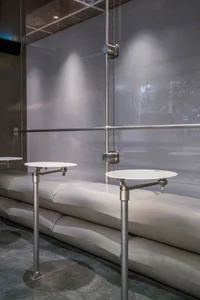 A sleek, modern restaurant bar featuring polished concrete surfaces and minimalist design elements.