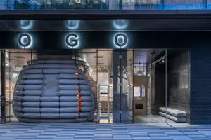 A minimalist retail storefront facade featuring a glass exterior and modern architectural elements.