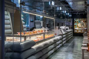 A modern cafe interior featuring a glass counter display.