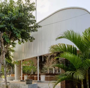 Photograph of a modern building with a curved, corrugated metal exterior.