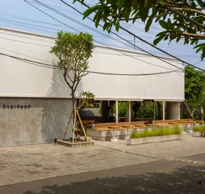 Modern industrial building exterior with concrete walls and minimalist design.