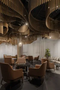 Modern lobby interior featuring spiral metal columns and comfortable seating
