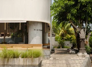 A modern public space with concrete, wood, and glass materials.