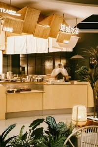 Modern restaurant interior with wooden accents and green plants