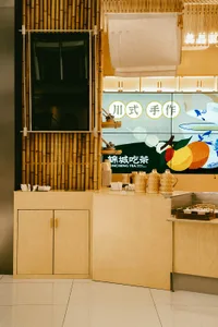 A restaurant counter area with bamboo walls and a counter setup.