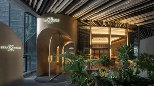 Modern coffee shop entrance with glass wall, wooden ceiling, and green plants