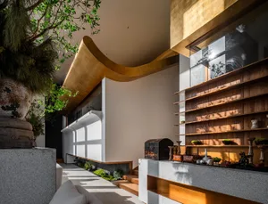 A modern living room featuring wooden shelving, concrete accents, and masonry elements.