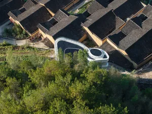 Aerial view of modern architecture featuring glass and concrete materials.