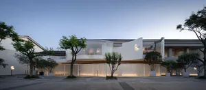 Modern residential exterior with white concrete cladding.
