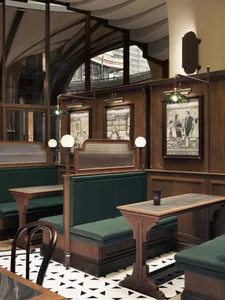 A cozy wooden cafe interior with plush leather benches.
