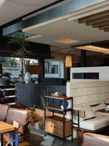 Modern cafe interior featuring wooden furniture and concrete walls