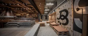 Industrial-style restaurant interior featuring timber materials and rustic decor.