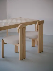 A modern interior design featuring a wooden table and chairs.