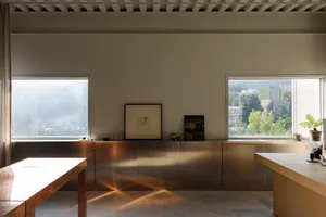 Modern office space featuring metallic cabinets, with views of the cityscape through the windows.