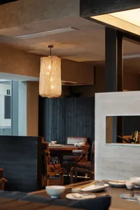 A modern restaurant interior with concrete and wooden elements.