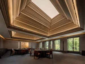 A modern restaurant interior with a wooden slat ceiling