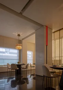 Modern restaurant dining room with marble and concrete finishes.