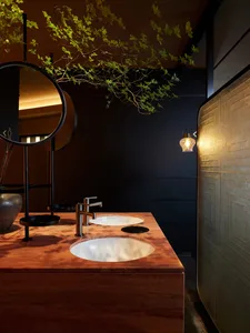 A modern bathroom with a marble countertop and minimalist design elements.