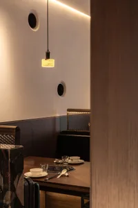Metallic-walled restaurant interior with minimalist design.