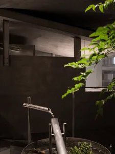 A modern, industrial office space featuring concrete walls and metal elements.