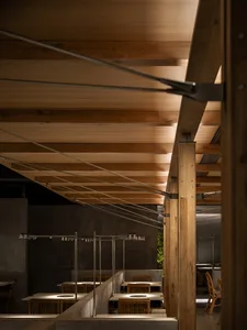 A photograph of an industrial restaurant interior featuring wooden elements.