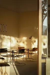 Modern cafe interior with metallic chairs and tables