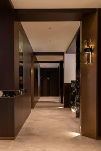 Modern hotel hallway with marble, wood, concrete flooring and ceiling lights
