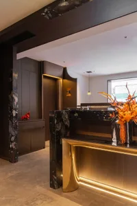Modern office reception desk featuring marble and metal materials.