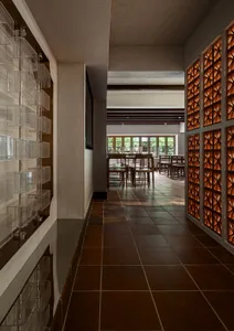 A modern restaurant interior with terrazzo tiles on the floor and walls.