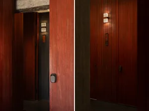 Entryway with dark wood paneling, modern design elements, and minimalist decor.