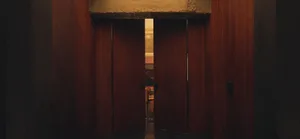 A wooden doorway with a light-colored interior.