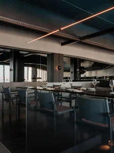 A modern industrial restaurant interior with concrete, glass, and metal materials