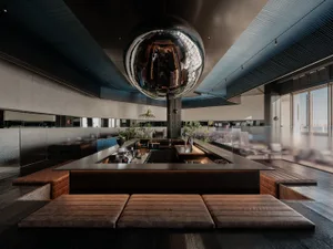 A contemporary bar design featuring metallic decor and luxurious leather seating.