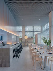 A modern restaurant interior featuring exposed concrete walls and wooden accents.