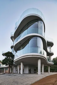 A modern office building featuring glass and concrete architecture.